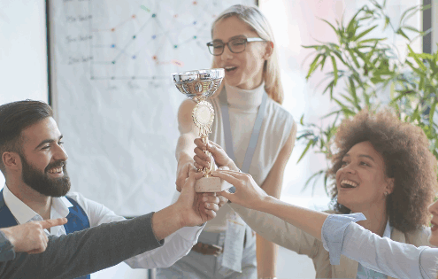 Diverse business team celebrating success together, holding a trophy in an office – teamwork, leadership, and business excellence concept.