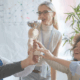 Diverse business team celebrating success together, holding a trophy in an office – teamwork, leadership, and business excellence concept.