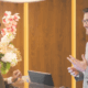 Hotel receptionist assisting a guest at the front desk, representing hospitality and guest experience.