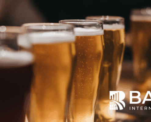 Close-up of beer glasses on a bar counter with the BARE International logo – representing quality evaluation, customer experience, and hospitality insights.