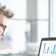 Professional reviewing customer satisfaction metrics on a laptop, representing mystery shopping insights and performance analysis.