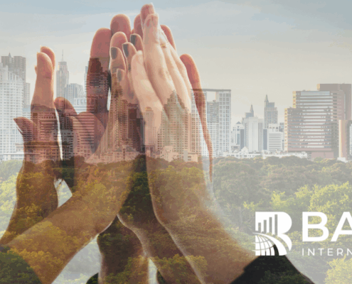 Hands coming together over a city skyline symbolizing ESG-driven customer experience, sustainability, and responsible business growth.