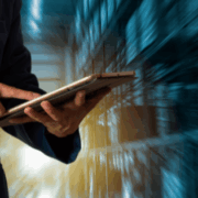 Business professional reviewing customer experience data on a tablet, representing how CX audits uncover hidden experience gaps and profit leaks for organizations.