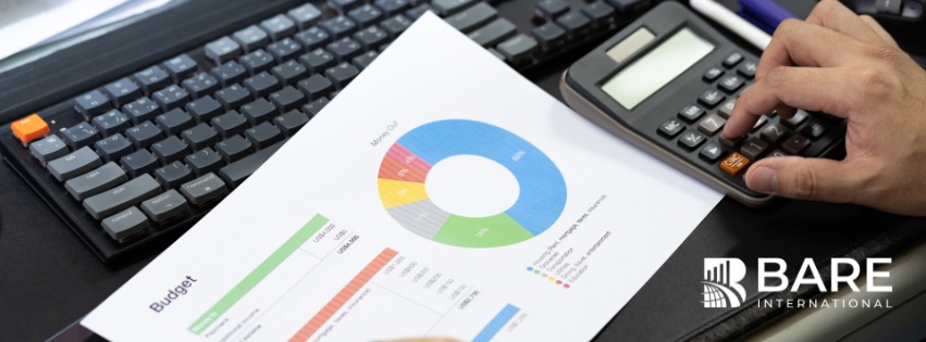 Business professional reviewing customer experience budget charts and analytics while calculating 2026 CX investment priorities.